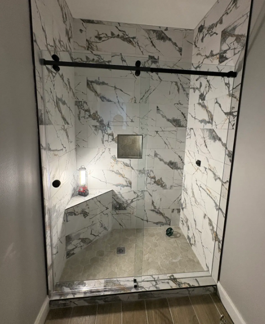 This is a classic Denali series sliding shower door from Frameless Hardware Company (FHC). It includes a finger cup to allow the sliding door to open all the way behind the fixed panel.